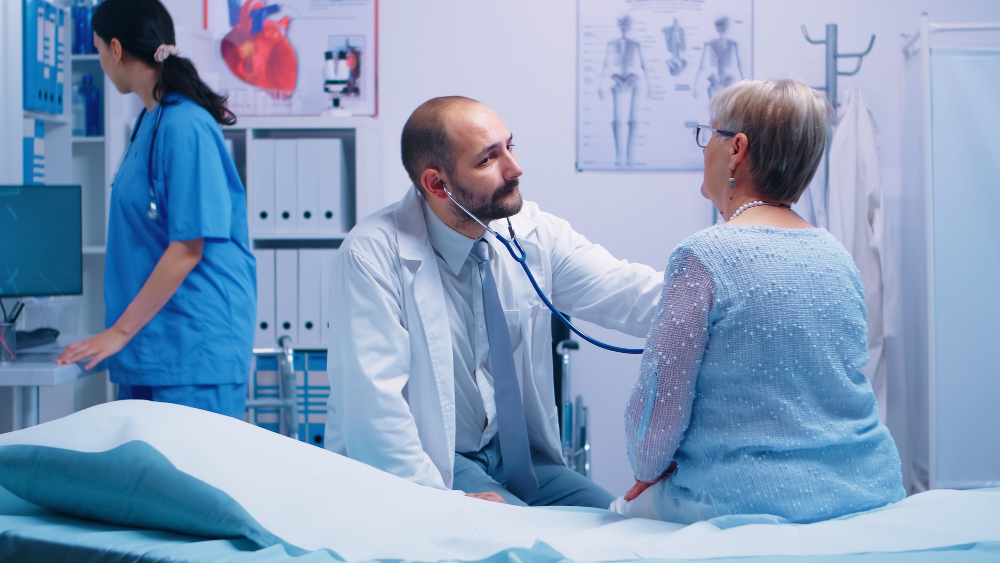 elderly-woman-doctor-appointment-modern-private-clinic-while-she-sitts-hospital-bed-physician-is-listening-her-heart-beat-health-care-medicine-treatment-specialist-consultation