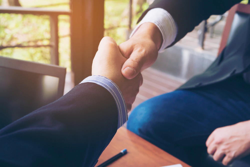 two-businessman-shake-hand-coffee-shop